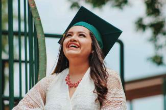 Woman with graduation cap looking at the sky